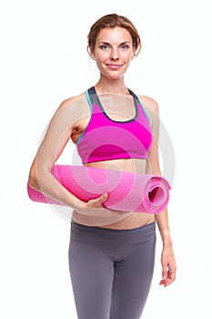 Portait of young woman with yoga mat.