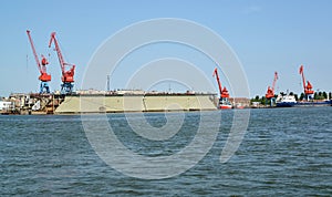 Portal cranes and floating ship dock from the sea. Kaliningrad region