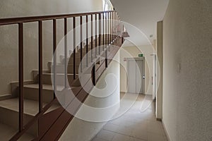 Portal of a house with stairs with brown metal railing