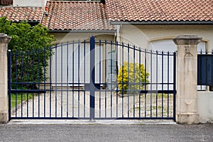 Portal old blue classic metal home gate at entrance of house garden door