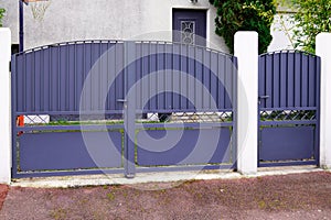 Portal old grey classic metal home gate at entrance of house garden gray door