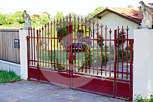 Portal old red classic metal home gate at entrance of house garden door