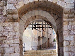 Portal of san jordi de montblanch with double arch voussoir in brown stone, tarragona, spain, europe