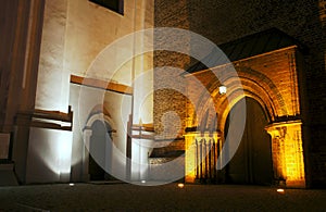 Portal to gothic church by night in Poznan