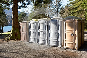 Portapotty in a park yard for public convenience photo