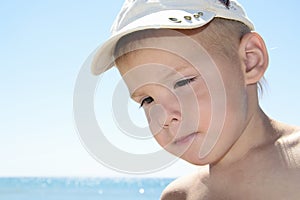 Portarit of boy on summer sea beach photo