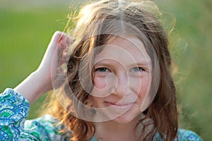 Portarit of Laughing curly girl isolated on green nature background