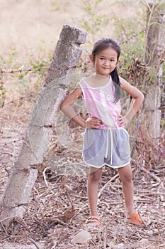 Portarit Thai little girl with barbed fence photo