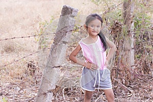 Portarit Thai little girl with barbed fence photo