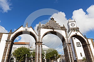 Portas da Cidade Gates and Saint Sabastian church with a clock tower in Ponta Delgada, Azores, Portugal.
