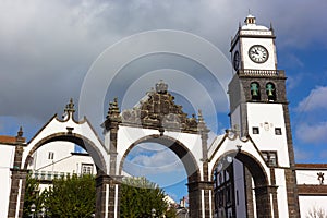 Portas da Cidade Gates and Saint Sabastian church with clock tower, Ponta Delgada, Portugal.