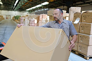 porter carrying boxes in warehouse