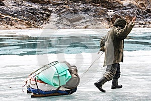 Porter Crossing Frozen Zanskar River. Chadar Trek