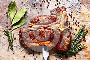 Porterhouse steak is speared with carving fork