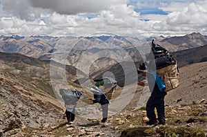 Porters with heavy load in the Himalaya