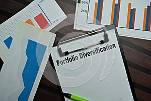 Portfolio Diversification write on a paperwork isolated on Wooden Table