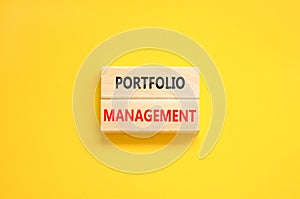 Portfolio management symbol. Concept words Portfolio management on beautiful wooden block. Beautiful yellow paper background.