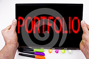 Portfolio text written on tablet, computer in the office with marker, pen, stationery. Business concept for Business Marketing Des