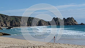 Porth Curno beach and Treen cliffs in Cornwall UK