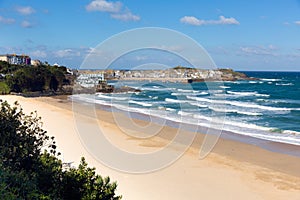 Porthminster beach and St Ives Cornwall England with white waves and blue sea and sky