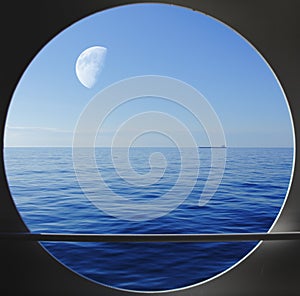 Porthole with blue ocean view photo