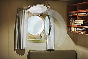 Porthole in the cabin of an old yacht