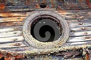 Porthole on old wooden ship