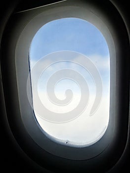 From the porthole of the plane at high altitude you can see the sky.