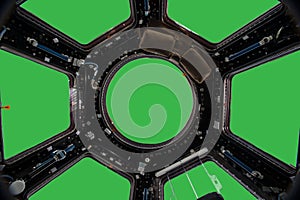Porthole of space station isolated on green background. Elements of this image furnished by NASA