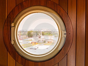 Porthole window looking out at port