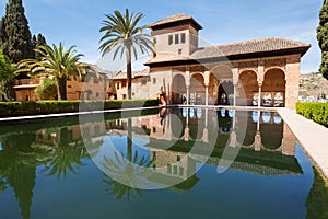 The portico in El Palacio del Partalâ€Š or Partal Palace reflected in goldfish pool. Albaicin old town, Alhambra castle