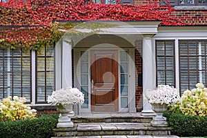 portico entrance and colorful ivy in fall