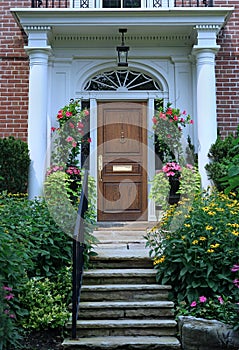 Portico entrance with elegant wood grain front door