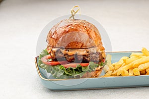 Portion of beef burger with french fries