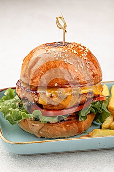 Portion of beef burger with french fries