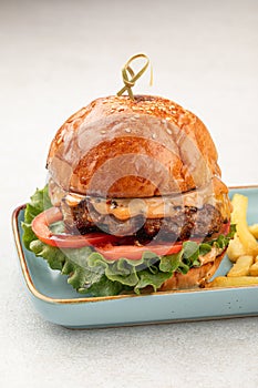 Portion of beef burger with french fries