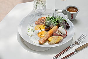 Portion of breakfast with sausage and fried eggs