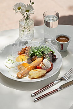 Portion of breakfast with sausage and fried eggs