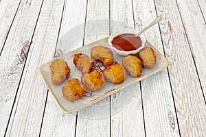 Portion of chicken nuggets battered in flour, egg and breadcrumbs