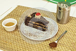 Portion of chocolate cake with three layers of sponge cake and filled with cream of coffee with milk, brown sugar and cocoa powder