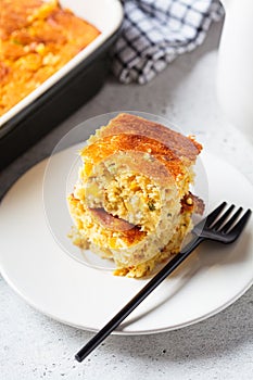 Portion of Christmas cheddar cornbread on white plate. Festive recipe food concept