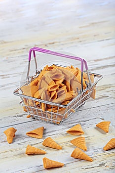Portion of cone shaped snack tornado shaped crackers. Yellow spicy potato cone chips texture or Background of corn cone