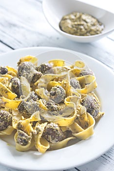 Portion of creamy mushroom pasta with pesto