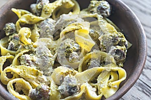 Portion of creamy mushroom pasta with pesto