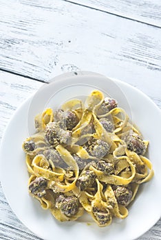 Portion of creamy mushroom pasta with pesto