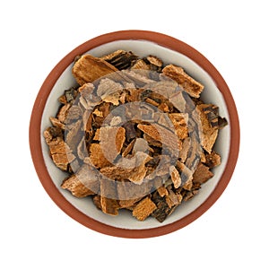 Portion of cut cherry tree bark in a small bowl