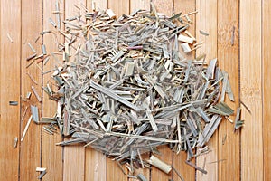 portion of dried organic lemongrass on rustic wooden table