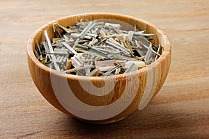 portion of dried organic lemongrass on rustic wooden table