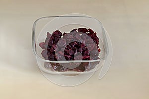 Portion of dried ripe Cranberry or Vaccinium oxycoccos fruit in a small bowl