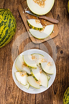 Portion of Fresh Futuro Melon on wooden background photo